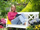 LADY ENJOYING AND RELAXING IN THE GARDEN