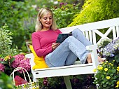 LADY ENJOYING AND RELAXING IN THE GARDEN