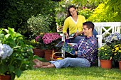 PEOPLE PERSONS ENJOYING BEING RELAXING IN THE GARDEN