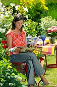 LADY ENJOYING AND RELAXING IN THE GARDEN