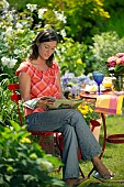 LADY ENJOYING AND RELAXING IN THE GARDEN