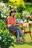 LADY ENJOYING AND RELAXING IN THE GARDEN