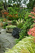 GENERAL GARDEN VIEW, STONE PLANTER, CROCOSMIA LUCIFER, KNIPHOFIA LITTLE MAID