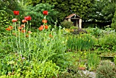 GARDEN VIEW OVER POND TO BRICK STRUCTURE