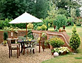 WOODEN FURNITURE ON GRAVEL PATIO