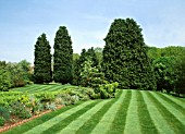 COUNTRY GARDEN WITH FRESHLY CUT LAWN STRIPES.