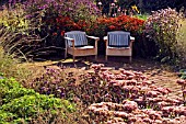 GARDEN SEATS ON PATIO IN THE PERENNIAL MEADOW GARDEN SCAMPSTON WALLED GARDEN