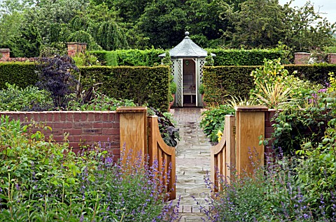 OPEN_WOODEN_GATE_BRICK_PATH_LEADING_TO_SUMMERHOUSE_AT_WOLLERTON_OLD_HALL