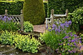 TERRACED SEATING AREA WITH ALCHEMILLA MOLLIS AT WOLLERTON OLD HALL