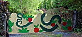 CONTEMPORARY HAND CRAFTED STEEL GATE SCULPTURE OF EVE THE APPLE AND THE SERPENT, GARDEN ART, WITHIN CONWY VALLEY MAZE
