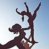 MATISSE INSPIRED CONTEMPORARY STEEL SCULPTURE CAPTURING THREE GIRLS IN SILHOUETTE WITH SWEEPING ATHLETIC POSES CALLED TOUCHING STARS, GARDEN ART, WITHIN CONWY VALLEY MAZE