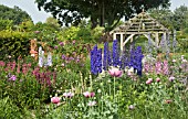 DEEP BORDERS OF MIXED COLOURS AND OAK PERGOLA AT WOLLERTON OLD HALL