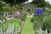 HERBACEOUS PERENNIALS WITH GRASS PATH LEADING TO OAK PERGOLA AT WOLLERTON OLD HALL