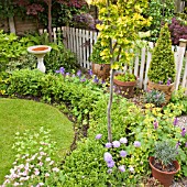 TERRACOTTA POTS AROUND CIRCULAR LAWN AT HIGH MEADOW GARDEN