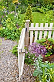 OPEN WOODEN GARDEN GATE AND GRAVEL PATH AT HIGH MEADOW GARDEN