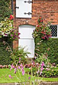 FRONT OF COTTAGE WITH HANGING BASKETS AT MILL HOUSE COTTAGE