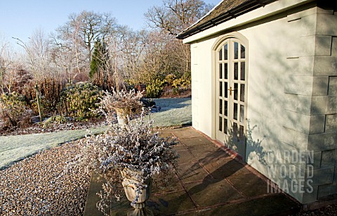 BORDERS_OF_MATURE_TREES_AND_SHRUBS_SUMMERHOUSE_IN_WINTER_SUNSHINE_AT_WILKINS_PLECK