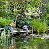 Pond area with decking silver balls grey slate plinths