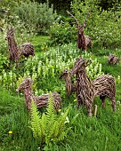 Ornamental Willow Deer grazing in meadow at John Masseys Garden, Ashwood, West Midlands