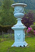 Enormous Cast Iron Urn on plinth Garden Art, within Conwy Conwy Valley Maze at Dolgarrog in Snowdonia National Park, Gwynedd, North Wales UK, in Late Spring.