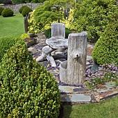 Unusual carved wooden furniture on circular slate area