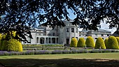 Mansion house with clipped Yew domes ornate water fountain