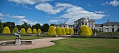 Mansion house with clipped Yew domes ornate water fountain