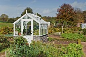Old style small white wooden greenhouse