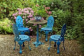 Seating area ornate iron garden table and chairs in blue