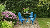 Seating area ornate iron garden table and chairs in blue