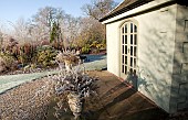 Borders of mature trees and shrubs summerhouse