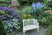 White metal bench border of herbaceous perennials