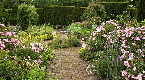 Scented_Garden_paved_path_leading_to_box_hedging_with_stone_bench_ornate_sundial