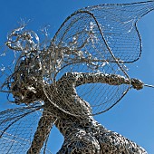 Fairy wire garden sculpture set against a blue sky