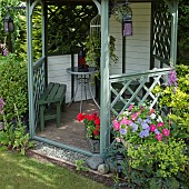 Wooden Gazebo containers planted with Petunias and Pelargoniums,