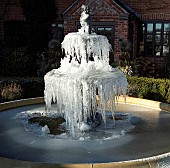 Frozen ornate water fountain and statue