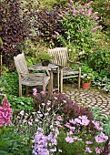 Seating in quiet corner of colour themed garden