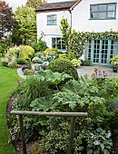 Flower Garden patio area borders with mature shrubs and trees sweeping lawns