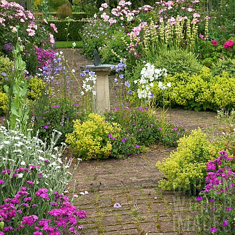 Scented_Garden_paved_path_leading_to_box_hedging_ornate_sundial_with_butterfly_feature