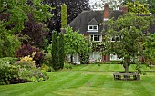 Herbaceous borders, mature trees, pitch and put on well kept lawn
