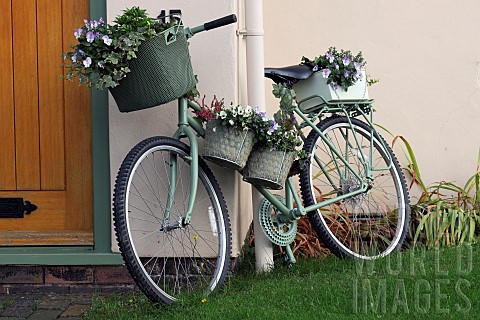 Front_garden_porch_an_old_pushbike_with_containers_of_flowers
