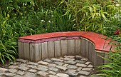 Cobbled patio with homemade wooden garden seat