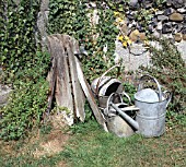 WATERING CANS AT THE BASE OF STAND PIPE