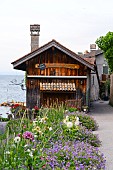 HOUSE ON LAKE LEMAN IN FRANCE WITH PRETTY GARDEN INCLUDING DAHLIA, GERANIUM AND VERBENA.