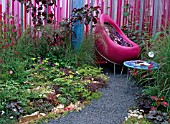 PATIO LOOKING AT THE WORLD THROUGH ROSE TINTED SPECTACLES.DESIGNED BY FERN ALDER AND WENDY SMITH.RHS HAMPTON COURT FLOWER SHOW 2004