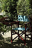 GARDEN CHAIR IN DAPPLED SHADE