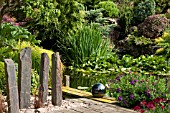 JOHNS GARDEN AT ASHWOOD NURSERIES   POOL WITH SURROUNDING SHRUBS CONIFERS TREE AND STAGING