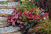 COLOURFUL BORDER SFTENING PATH OF RAILWAY SLEEPER AND GRANITE CHIPPINGS