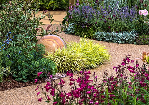PATH_OF_RESIN_COATED_SHINGLE_EDGED_WITH_COLOURFUL_PERENNIALS