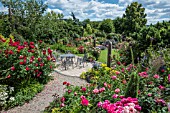 GARDEN PATIO AREA SURROUNDED WITH ROSES WITH PERENNIALS